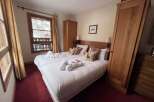 Experience cozy mountain living in this charming bedroom featuring two comfortable beds, perfect for a relaxing getaway.