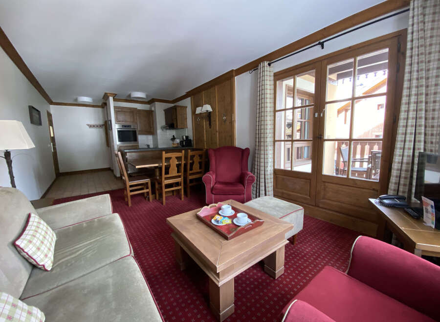 Experience comfort and style in this inviting living space, featuring a plush sofa and a cozy armchair perfect for relaxation.