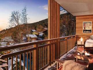 Experience the ultimate mountain retreat from this stunning balcony, complete with a cozy fireplace and breathtaking winter views.