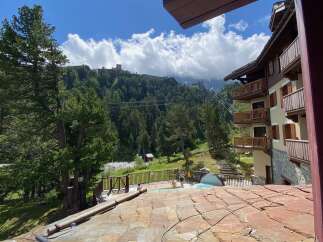 Experience luxury mountain living with this stunning property featuring a private hot tub overlooking a lush forest and majestic mountains.