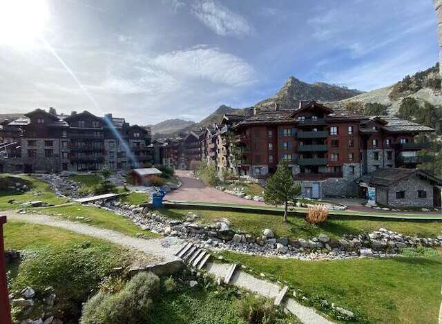 Experience mountain living in this stunning property featuring modern architecture seamlessly integrated with natural stone and wood elements.