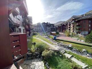 Experience mountain living in this charming alpine village setting, featuring traditional wooden chalets and stunning natural surroundings.