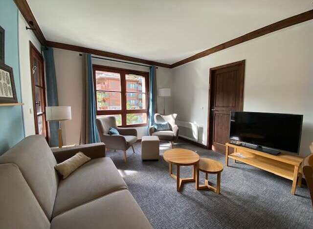 Experience comfort and style in this inviting living room, featuring a plush sofa and two cozy armchairs perfect for relaxation.