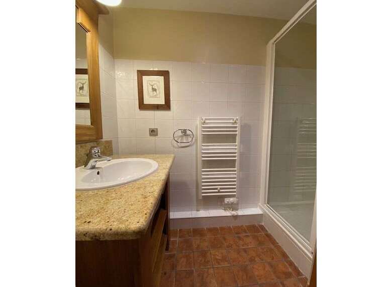 This charming bathroom features a spacious vanity with a granite countertop and a modern sink, perfect for your morning routine.