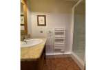 This charming bathroom features a spacious vanity with a granite countertop and a modern sink, perfect for your morning routine.