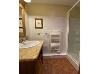 This charming bathroom features a spacious vanity with a granite countertop and a modern sink, perfect for your morning routine.