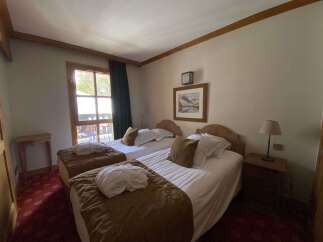 Experience comfort and tranquility in this charming hotel room, featuring two cozy twin beds perfect for a restful night's sleep.
