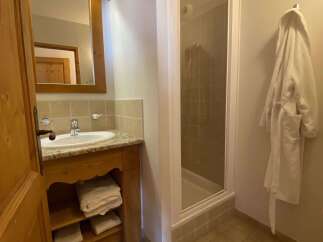 This charming bathroom features a spacious vanity with ample storage, a modern sink, and a well-lit mirror.
