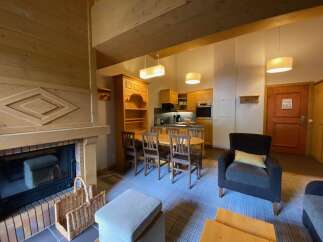 Experience cozy living in this charming mountain retreat, featuring a rustic stone fireplace perfect for chilly evenings.