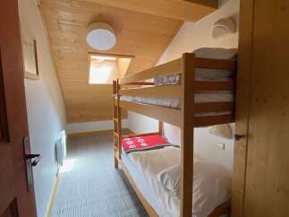 This charming room features a cozy bunk bed setup, perfect for families or groups.