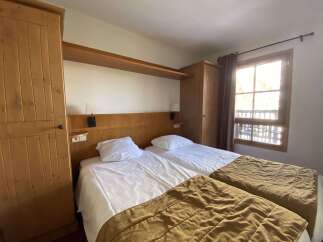 This charming bedroom features two comfortable twin beds, perfect for accommodating guests or family.