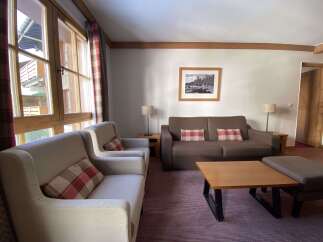 Experience comfort and style in this inviting living space, featuring plush seating arrangements perfect for relaxation.