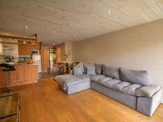 Discover this charming studio apartment featuring a modern kitchenette with ample cabinet space and a breakfast bar.