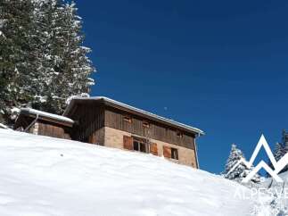 Nestled amidst a winter wonderland, this charming property offers a serene mountain escape.