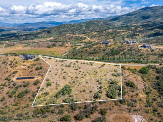 Discover this expansive parcel of land offering breathtaking panoramic views of the surrounding mountains and valley.
