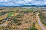 Experience luxury living with this stunning aerial view of a modern estate nestled in a picturesque landscape.