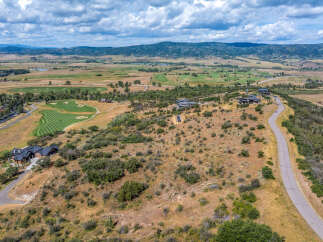 Experience luxury living with this stunning aerial view of a modern estate nestled in a picturesque landscape.