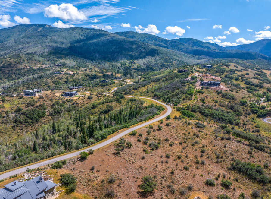 Discover luxury living nestled in the scenic mountains with this stunning aerial view of modern homes.