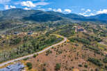 Discover luxury living nestled in the scenic mountains with this stunning aerial view of modern homes.