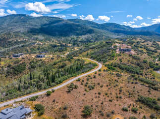 Discover luxury living nestled in the scenic mountains with this stunning aerial view of modern homes.