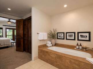 Indulge in relaxation in this luxurious bathroom featuring a deep soaking tub, perfect for unwinding after a long day.