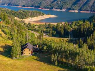 Nestled amidst a lush forest and overlooking a serene lake, this stunning property offers the perfect blend of natural beauty and comfortable living.