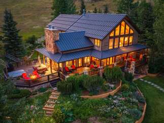 Experience luxury mountain living in this stunning timber-frame home, featuring expansive decks, a stone fireplace, and a gourmet kitchen.