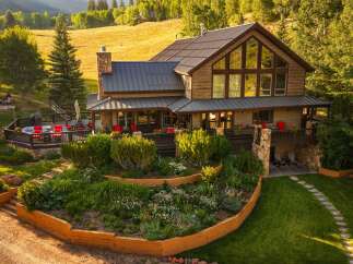 Experience luxury mountain living in this stunning timber-frame home, featuring expansive windows that capture breathtaking views.