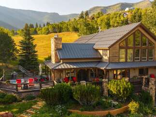 Experience luxury mountain living in this stunning log home, featuring a spacious deck with a hot tub and breathtaking views.