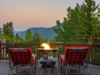 Experience breathtaking mountain views from this stunning deck, perfect for evening relaxation.