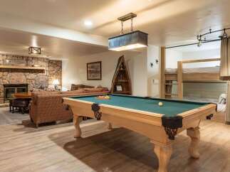 This rustic basement living area offers a perfect blend of entertainment and relaxation.