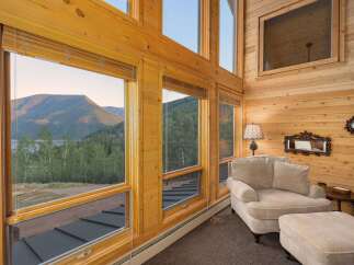 Experience breathtaking mountain and lake views from this stunning log home's expansive windows.