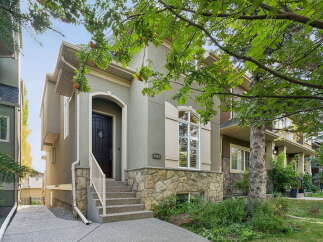 Discover this charming home featuring a welcoming stone-accented facade and an arched entryway.