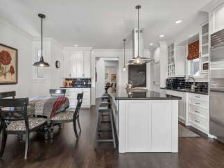This spacious kitchen boasts a large island with seating, perfect for casual dining and entertaining.