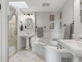 Indulge in luxury with this stunning bathroom featuring a spacious corner soaking tub, perfect for unwinding after a long day.
