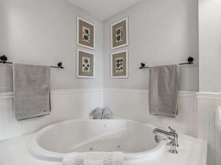 Indulge in relaxation in this luxurious bathroom, featuring a spacious jacuzzi tub perfect for unwinding.