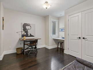 This home office space features a striking black and white portrait of James Dean above a vintage-style desk, creating a unique focal point.
