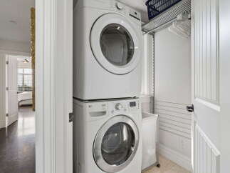 Discover the convenience of a dedicated laundry space featuring a stacked LG washer and dryer.