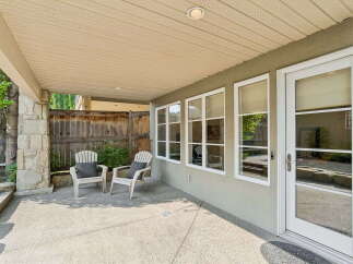 Enjoy outdoor living on this covered patio, perfect for relaxing or entertaining.