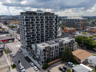 Discover modern urban living in this stunning apartment complex, featuring a sleek design with private balconies and expansive windows.