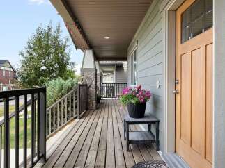 Welcome guests to this charming home with a spacious covered porch, perfect for enjoying the outdoors.