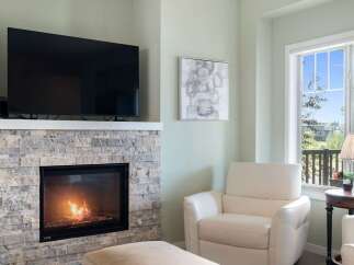 Cozy up by the modern stone fireplace, perfect for chilly evenings.