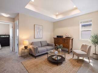 Discover this inviting living space featuring a comfortable grey sofa and a stylish accent chair, perfect for relaxation.