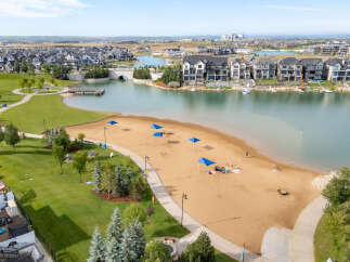 Experience lakeside living at its finest in this stunning community, featuring a beautiful sandy beach perfect for relaxation and recreation.