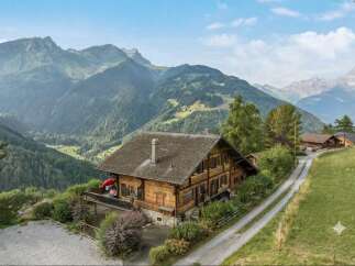 Experience breathtaking mountain views from this stunning wooden chalet, nestled amidst lush greenery and rolling hills.