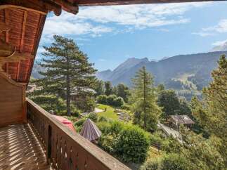 Experience breathtaking mountain views from this charming wooden balcony, perfect for enjoying your morning coffee or evening wine.