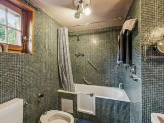 This charming bathroom features a classic bathtub with a shower curtain, perfect for relaxing soaks.