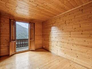 Experience breathtaking mountain views from this charming wooden interior room.