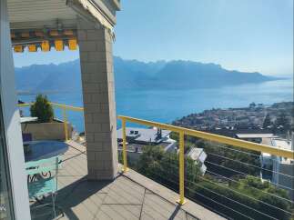 Enjoy breathtaking panoramic views of the lake and mountains from this stunning property's balcony.