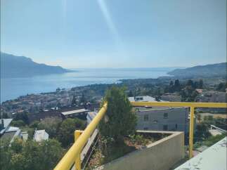 Experience breathtaking panoramic views of the serene lake and majestic mountains from this stunning property.